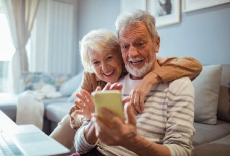 A couple of seniors doing a video call to their family.